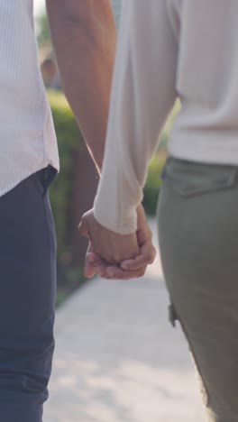 Vertical-Video-Close-Up-Shot-Of-Loving-Muslim-Couple-On-Date-Walking-And-Holding-Hands-1